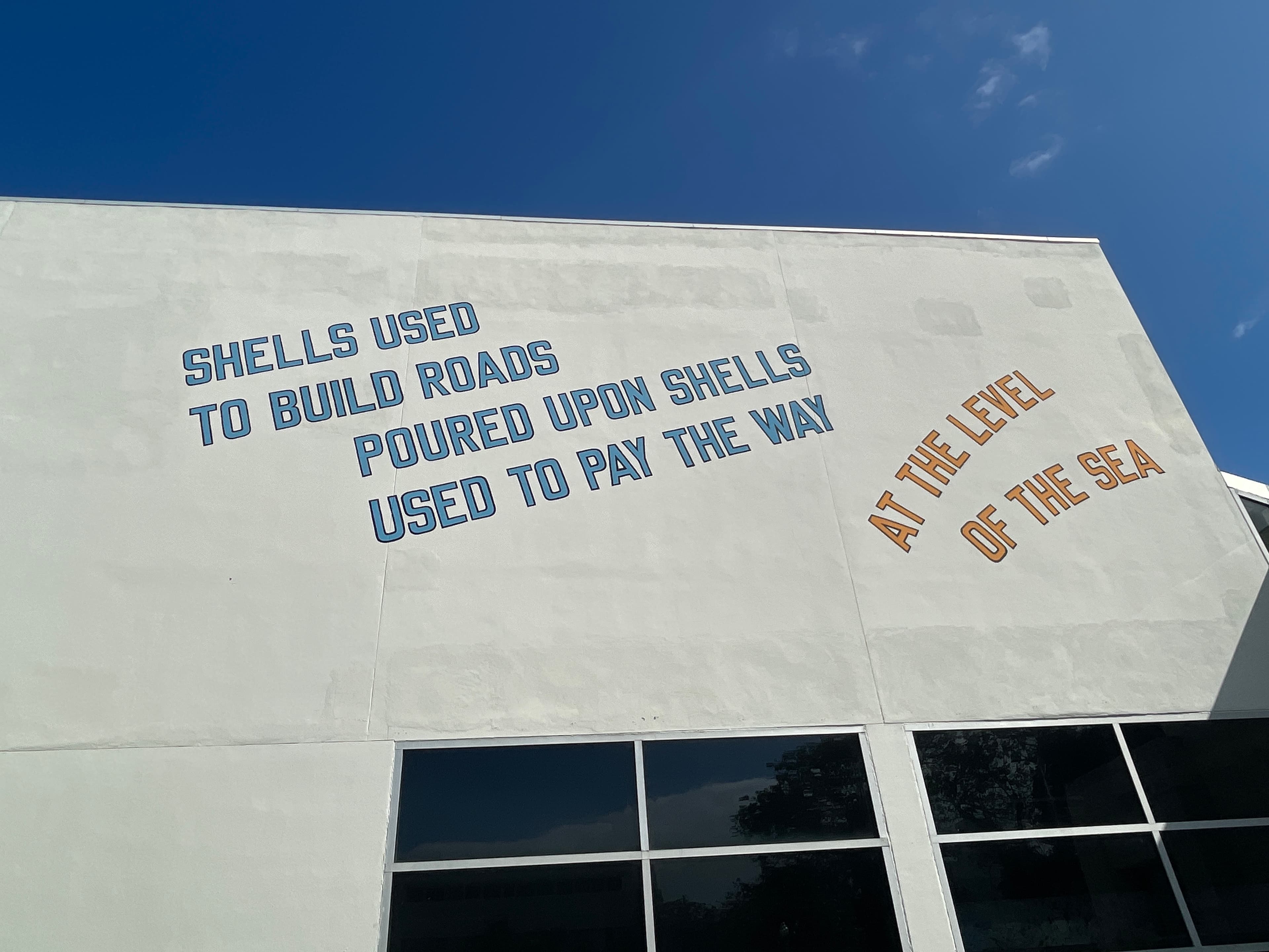 Shells used to build roads poured upon shells used to pay the way at the level of the sea