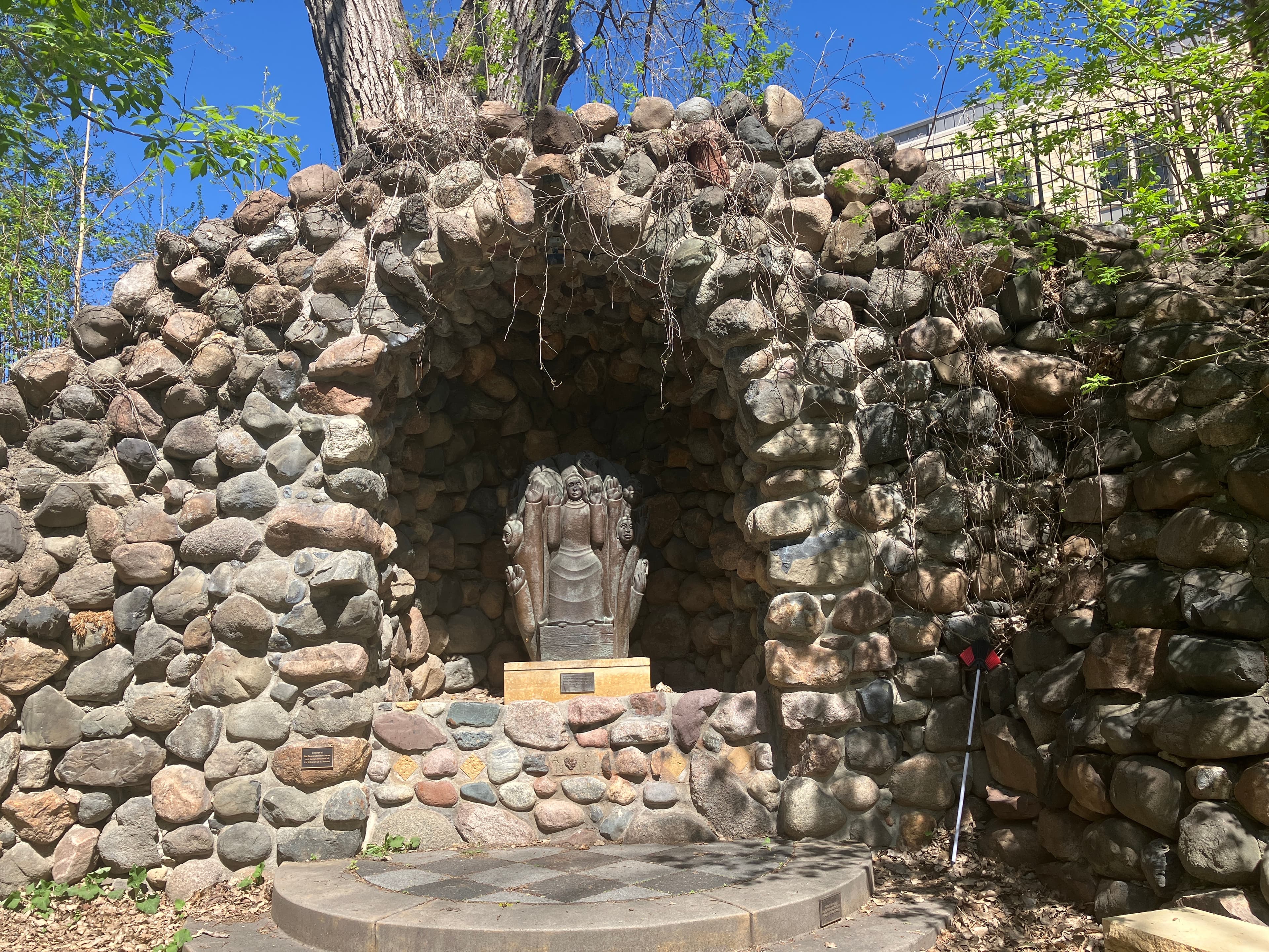 Grotto with sculpture with hands and faces
