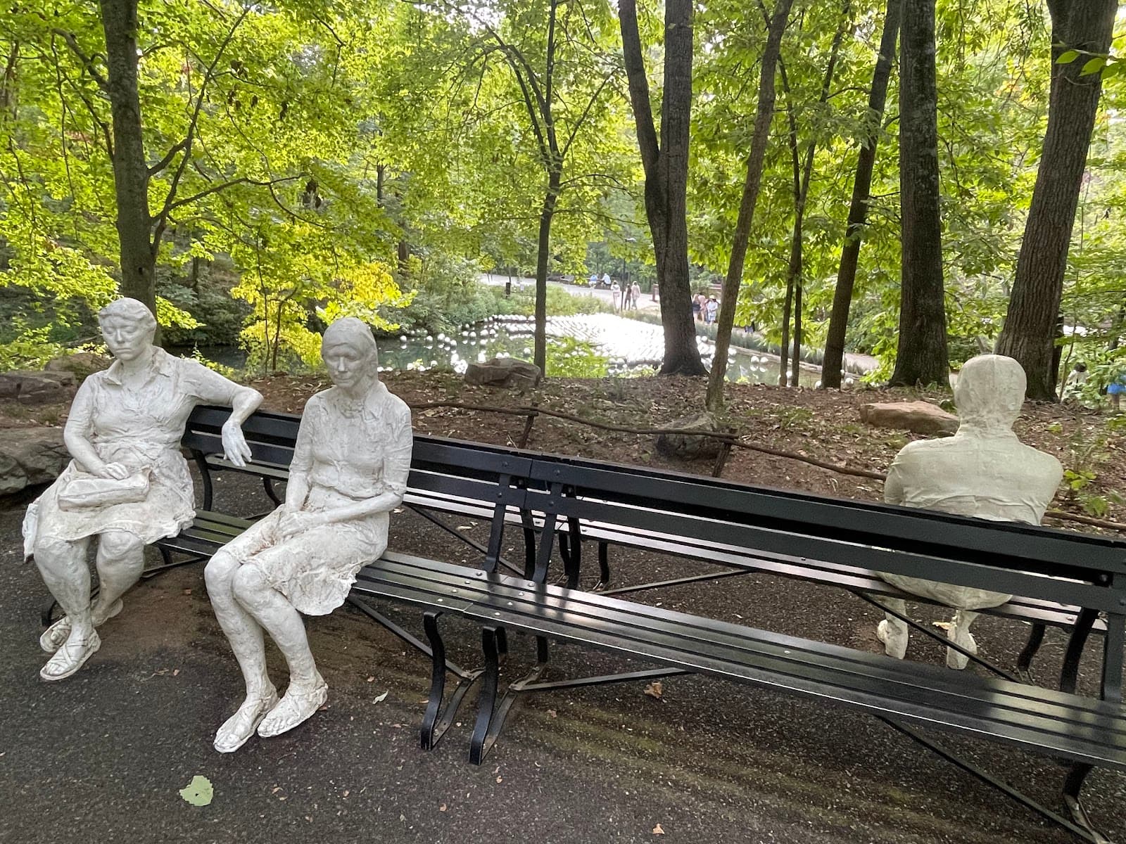 Three People on Four Benches Sculpture